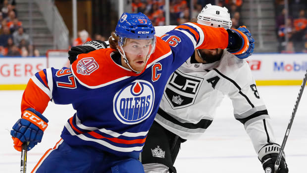 Edmonton Oilers forward Connor McDavid (97) battles for position with Los Angeles Kings defensemen Drew Doughty (8).